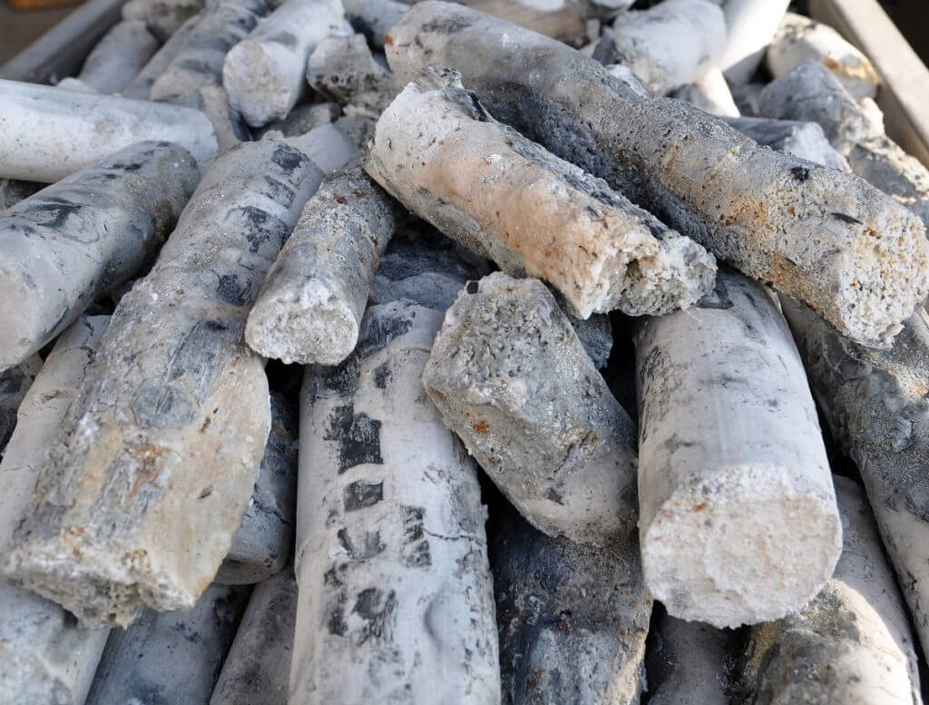Bamboo salt pillars after first high-temperature firing, showing ash and mineral residue